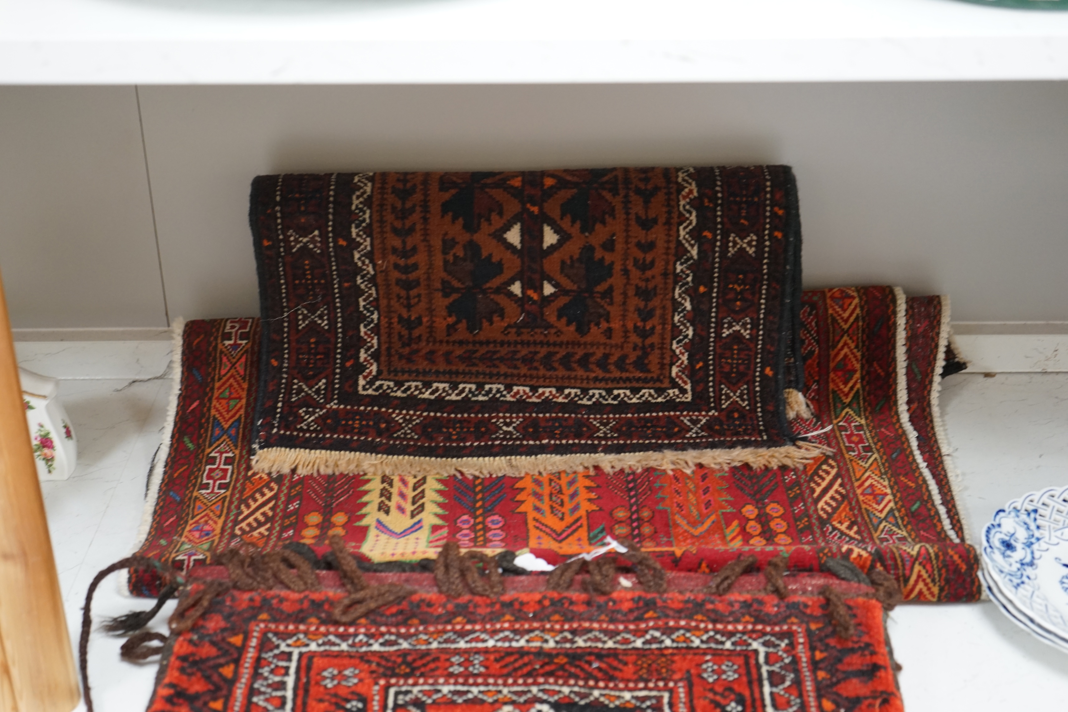A saddle bag and two prayer rugs. Condition - fair